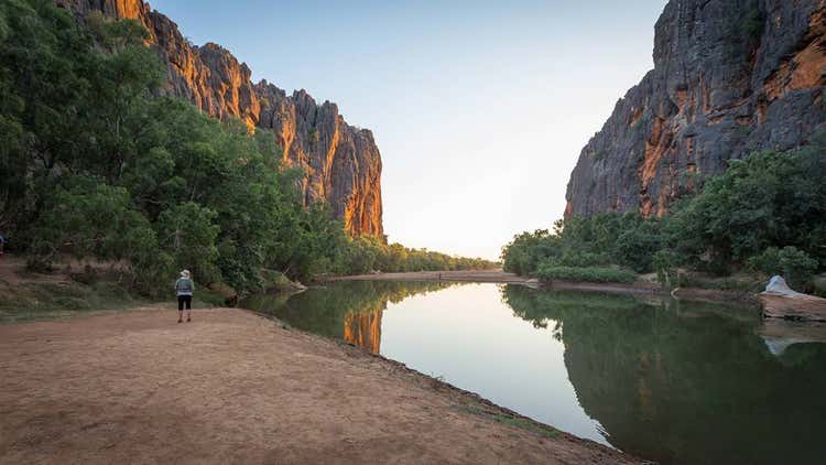 The Lennard River carves a stunning canyon through the Napier Range at Windjana Gorge, Kimberley Region, Western Australia. The permanent pools in the river provide a permanent habitat for dozens of freshwater crocodiles. Rudyards Kipling's story "The Elephant Child," comes to mind every time I visit Windjana Gorge in the Kimberley, when the Elephant child says: "and still I want to know what the Crocodile has for dinner!'Then Kolokolo Bird said, with a mournful cry, 'Go to the banks of the great grey-green, greasy Limpopo River, all set about with fever-trees, and find out."At Windana Gorge the green waters of the gorge pools are filled with Johnston crocodiles floating in the tepid green waters or resting on the hot sand banks.They add a real air of wild Australia below the complex and colourful ramparts of the Gorge where the Leonard River flows through the ancient Devonian reefs.The history of the renegade aboriginal tracker Jandamarra who hid in caves in this gorge and the screeching of the galahs circling overhead and wheeling about amongst the crags further adds to the primeval atmosphere of this special place in Australia.